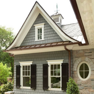 Custom home exterior renovation with stone and cedar finishes in Guelph, Ontario